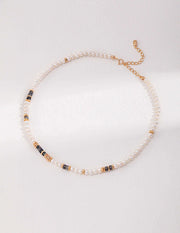 A stylishly designed Labradorite Necklace adorned with gold and black beads for a fashionable touch.