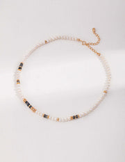 A stylishly designed Labradorite Necklace adorned with gold and black beads for a fashionable touch.