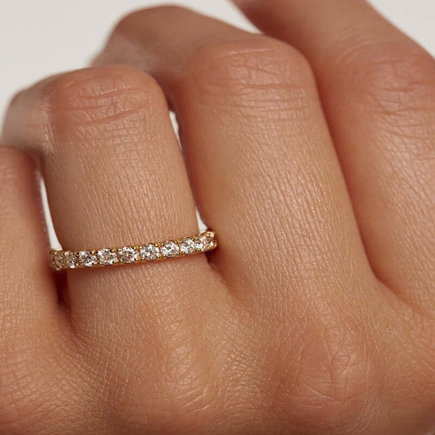 A woman's hand holding an Eternity Ring adorned with Zirconia, creating an eternal and trend-setting beauty.