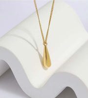 The Mermaid Tear Necklace, a symbol of elegance and sophistication, delicately rests on a pristine white surface.