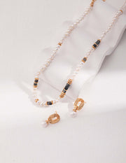 A stylishly designed Labradorite necklace and earring set on a white surface, adding a fashionable touch to any outfit.