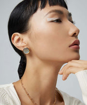 The model is wearing a white sweater and a pair of Eclipse Earrings.