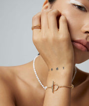 A woman wearing a Chloe's Pearl Bracelet.