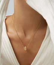 A woman wearing a white sweater with Harper's Pearl Wheel Necklace made of 18K White Gold.