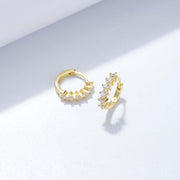 A pair of stylish Venus Huggie Hoop Earrings adorned with cubic zirconia, perfect for a work ensemble or any occasion.