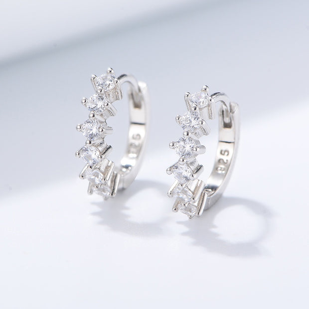 Add a touch of elegance to your work ensemble with the stylish Venus Huggie Hoop Earrings. Crafted from white gold and embellished with sparkling cubic zirconia, the Venus Huggie Hoop Earrings elevate your look.