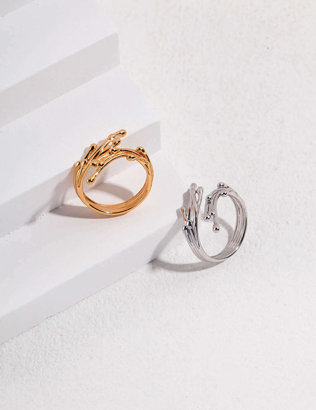 The Ethereal Twig Ring, a wardrobe staple, sitting on top of a white surface.
