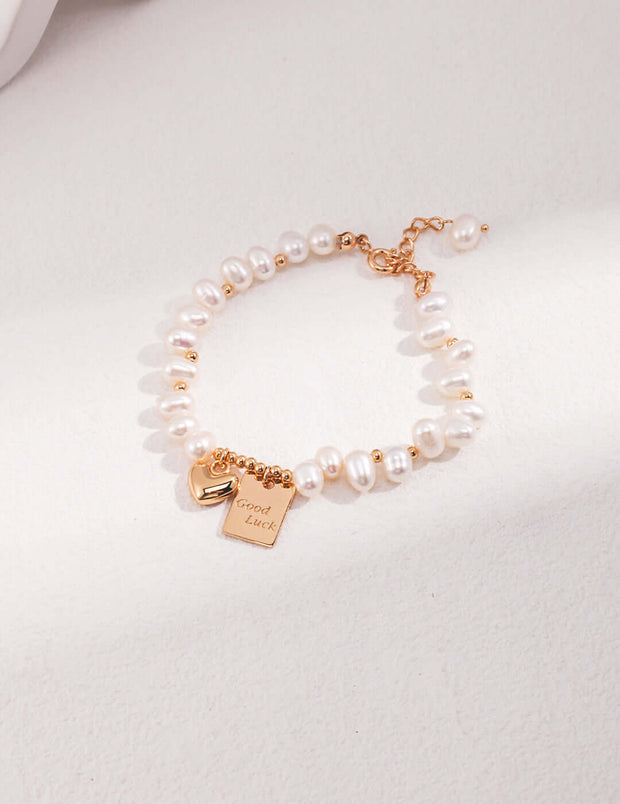 An elegant Golden Heart Pearl Bracelet with a rose gold charm.