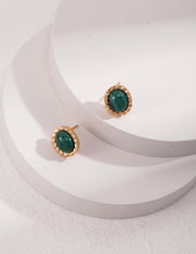 A pair of green stone Peacock stud earrings made with natural Malachite stone on a white surface.