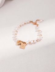 A Golden Heart Pearl Bracelet with a charm and natural pearls.