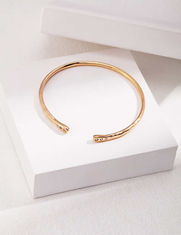 A timeless Minimalist Chic Bangle on top of a white box.