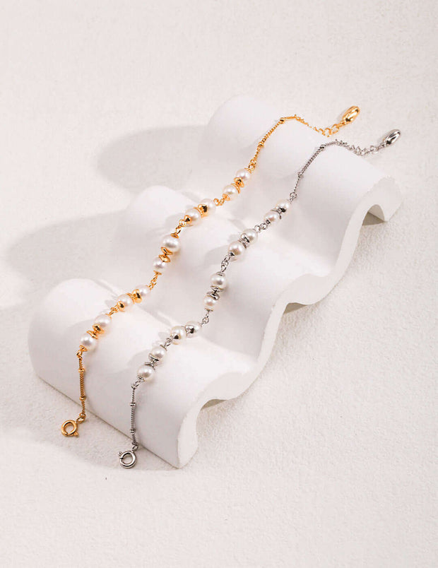 Three Whispering Pearls Bracelets with pearls on a white surface.