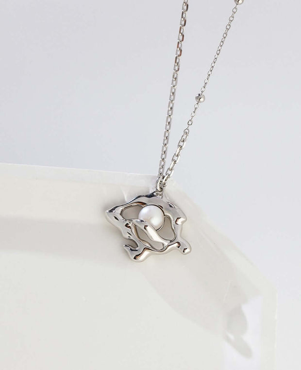 A Lunar Mist Necklace with a heart on it, featuring an extension chain for adjustable length.