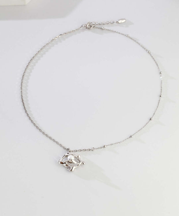 A silver Lunar Mist Necklace with a 18K white gold bird pendant.