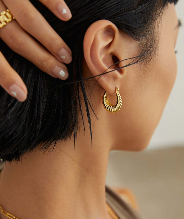 A woman wearing Stylish Hoop Earrings earring.