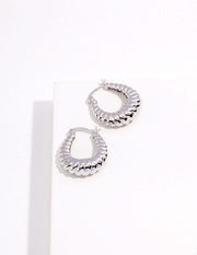 A pair of Stylish Hoop Earrings on a white surface.