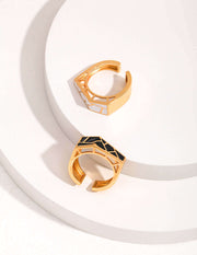 An eye-catching pair of Modernist Contrast Rings, featuring a unique design, placed on a pristine white surface.
