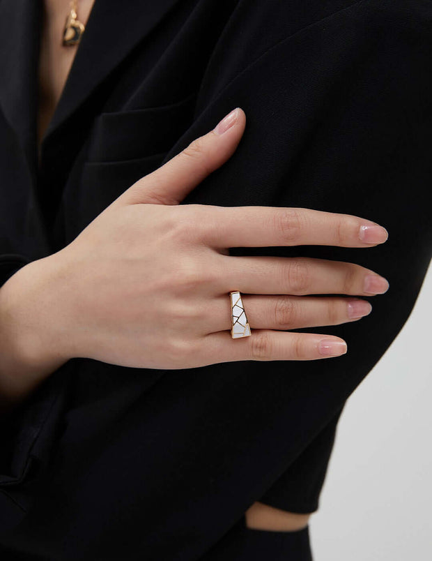 An eye-catching woman's hand holding a Modernist Contrast Ring.