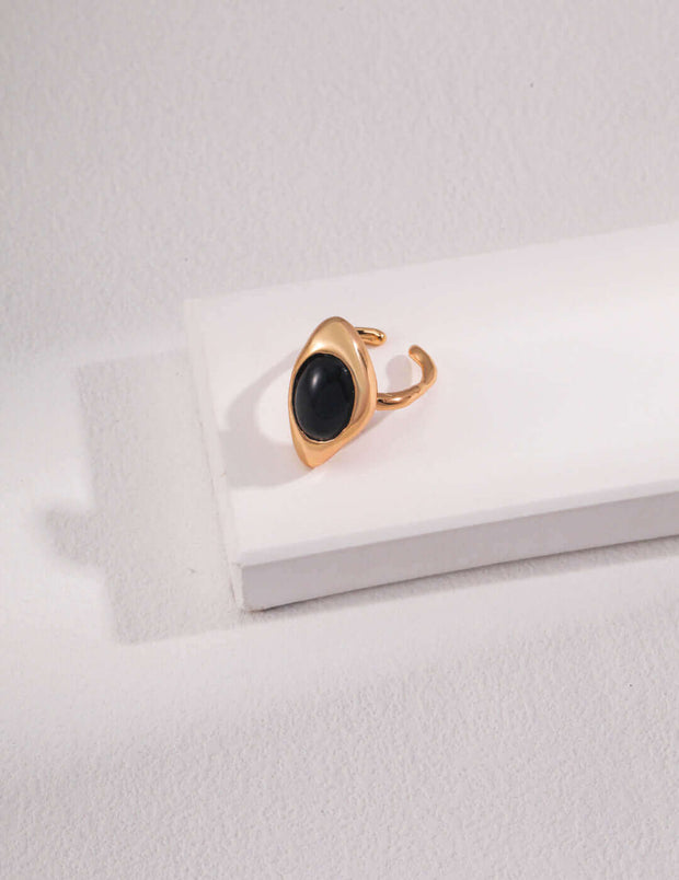 artisan carved agate ring with a black stone on top