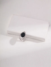 Artisan Carved Agate Ring with a black stone sitting on top of a white box.